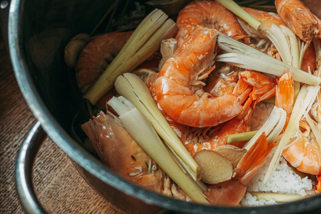 Preparation of flavorful shrimp soup with lemongrass in a pot.